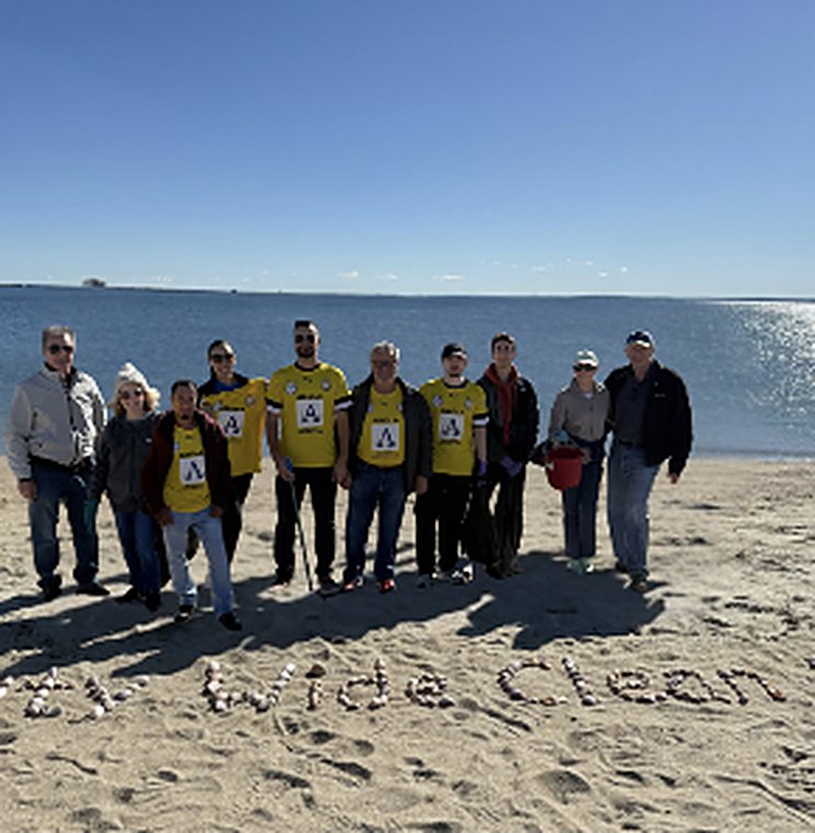 TPFF volunteers in yellow jerseys at the Stamford West Beach cleanup